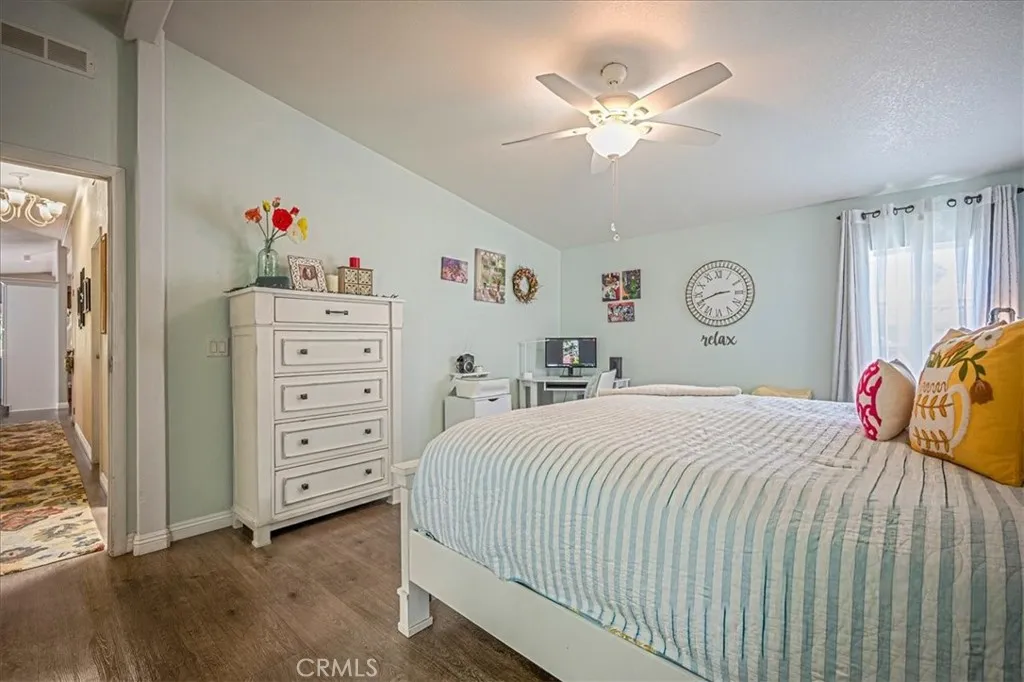 15181 Van Buren, Unit 178 Riverside, CA 92504 - Photo 18 of 52 a bedroom with a bed and a chandelier