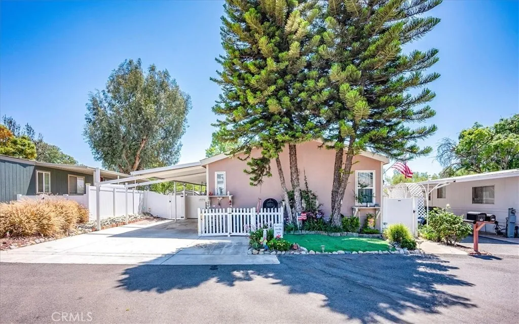15181 Van Buren, Unit 178 Riverside, CA 92504 - Photo 2 of 52 a front view of a house with a yard and potted plants