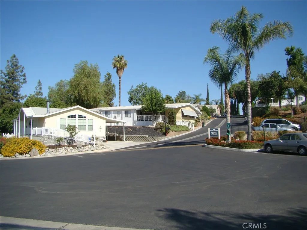 15181 Van Buren, Unit 178 Riverside, CA 92504 - Photo 34 of 52 a couple of cars parked in front of a house