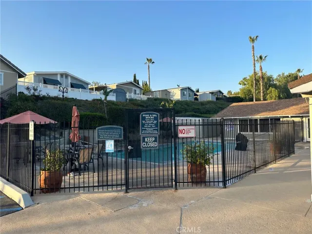 a view of a park with iron fence