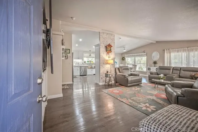 a kitchen with stainless steel appliances kitchen island granite countertop a refrigerator and a sink