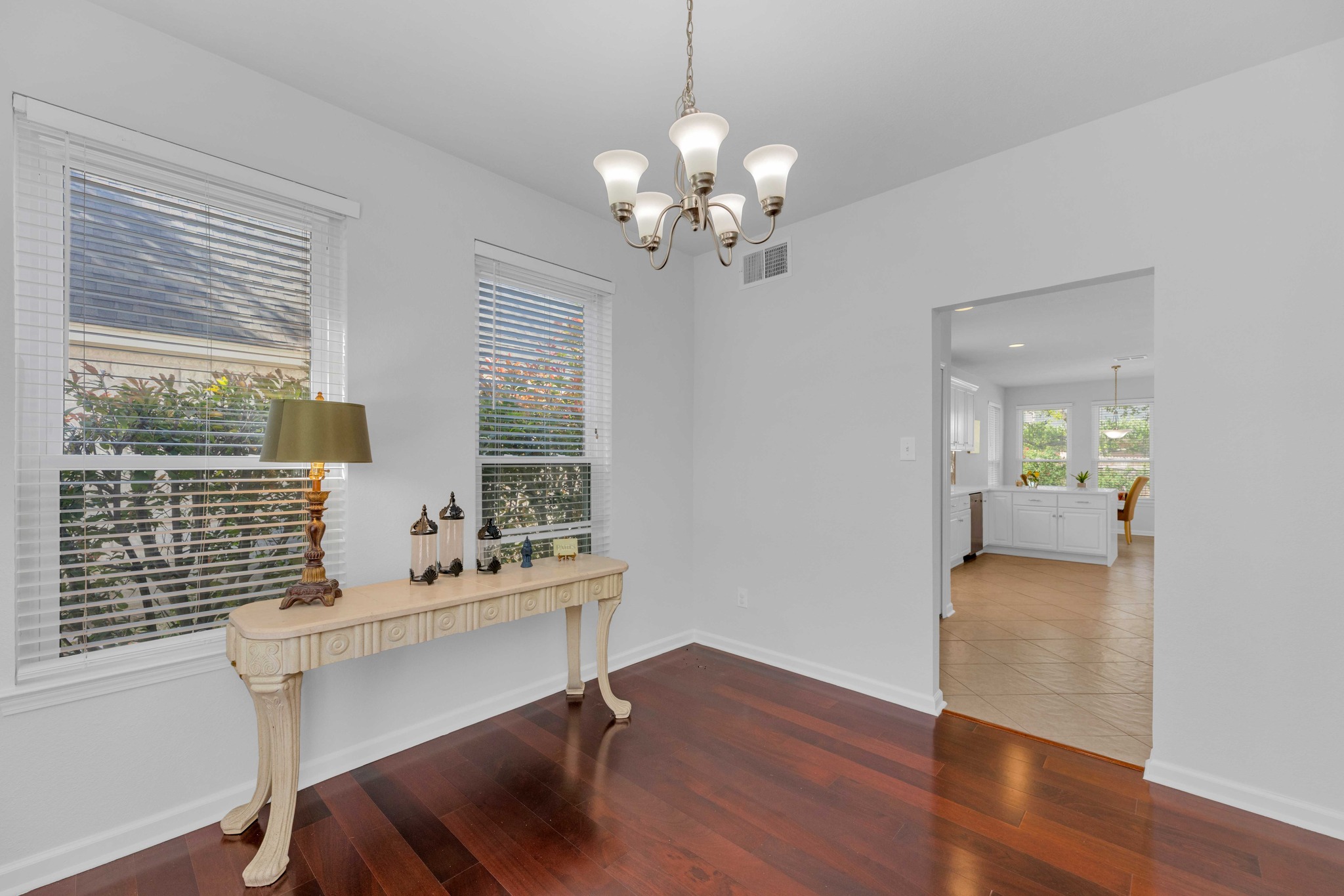 12528 Labrador Cove Austin, TX 78729 - Photo 11 of 40 Dining Area: Bright and inviting space with large windows, rich wood flooring, and easy access to the kitchen. Ideal for both everyday meals and entertaining, enhanced by natural light and a clean, modern feel.