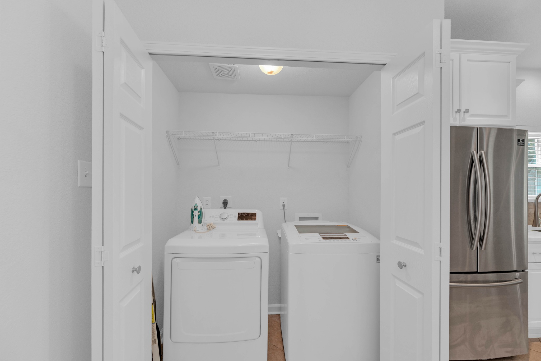 12528 Labrador Cove Austin, TX 78729 - Photo 13 of 40 Laundry: Convenient interior laundry area with full size washer and dryer connections, overhead storage, and easy access to the kitchen for everyday functionality.