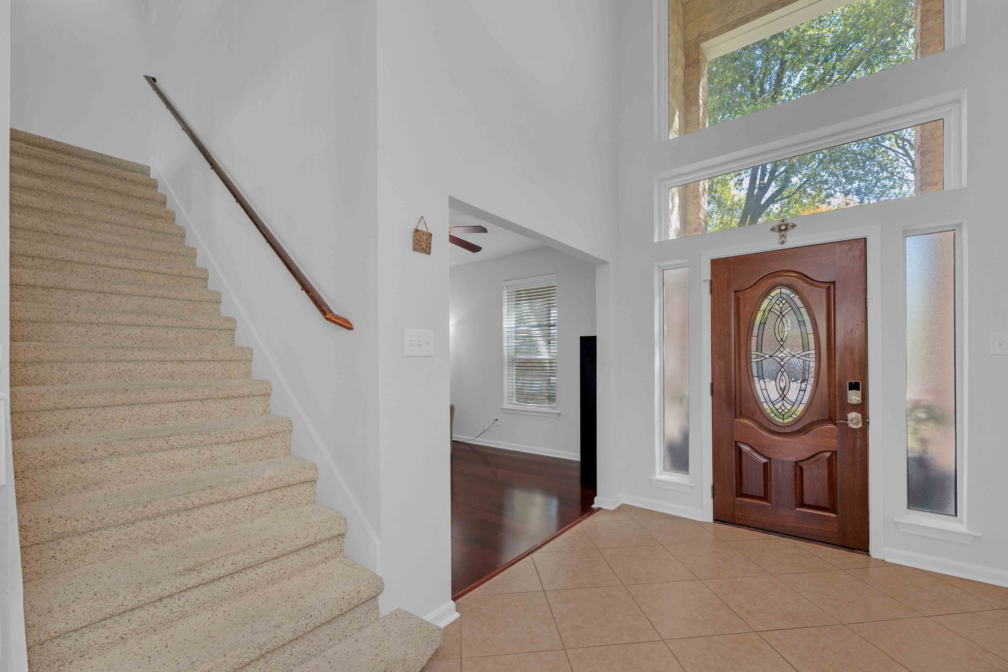 12528 Labrador Cove Austin, TX 78729 - Photo 2 of 40 Entry: Grand two story foyer with soaring ceilings and abundant natural light from oversized windows. Elegant front door with decorative glass creates a strong first impression, while the open staircase and clean modern lines set the tone for the home’s inviting layout.