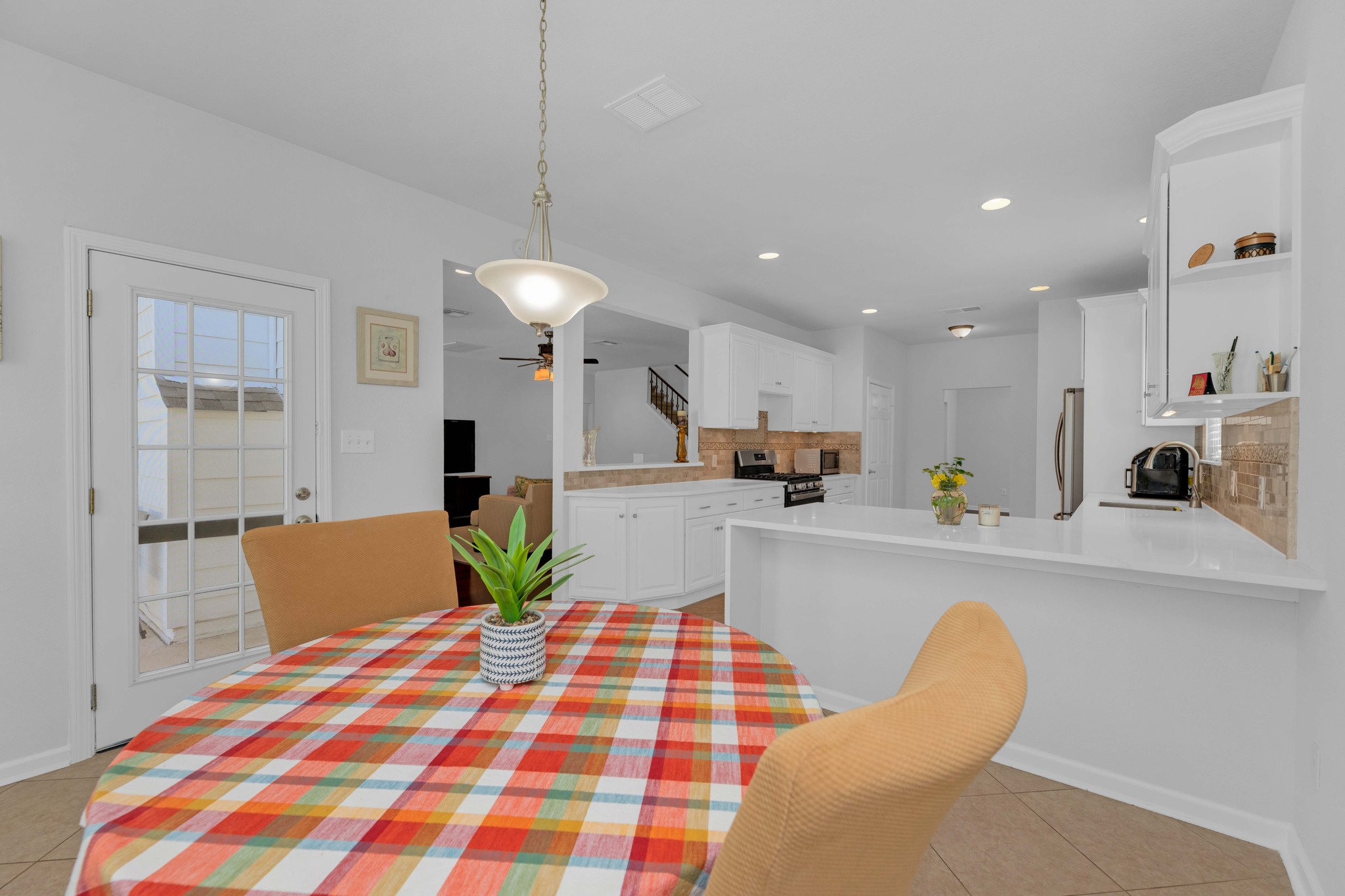 12528 Labrador Cove Austin, TX 78729 - Photo 22 of 40 Breakfast Area: Bright and inviting dining space with large windows and natural light, seamlessly connected to the kitchen. Ideal for casual meals, with an open layout that enhances everyday living and entertaining.
