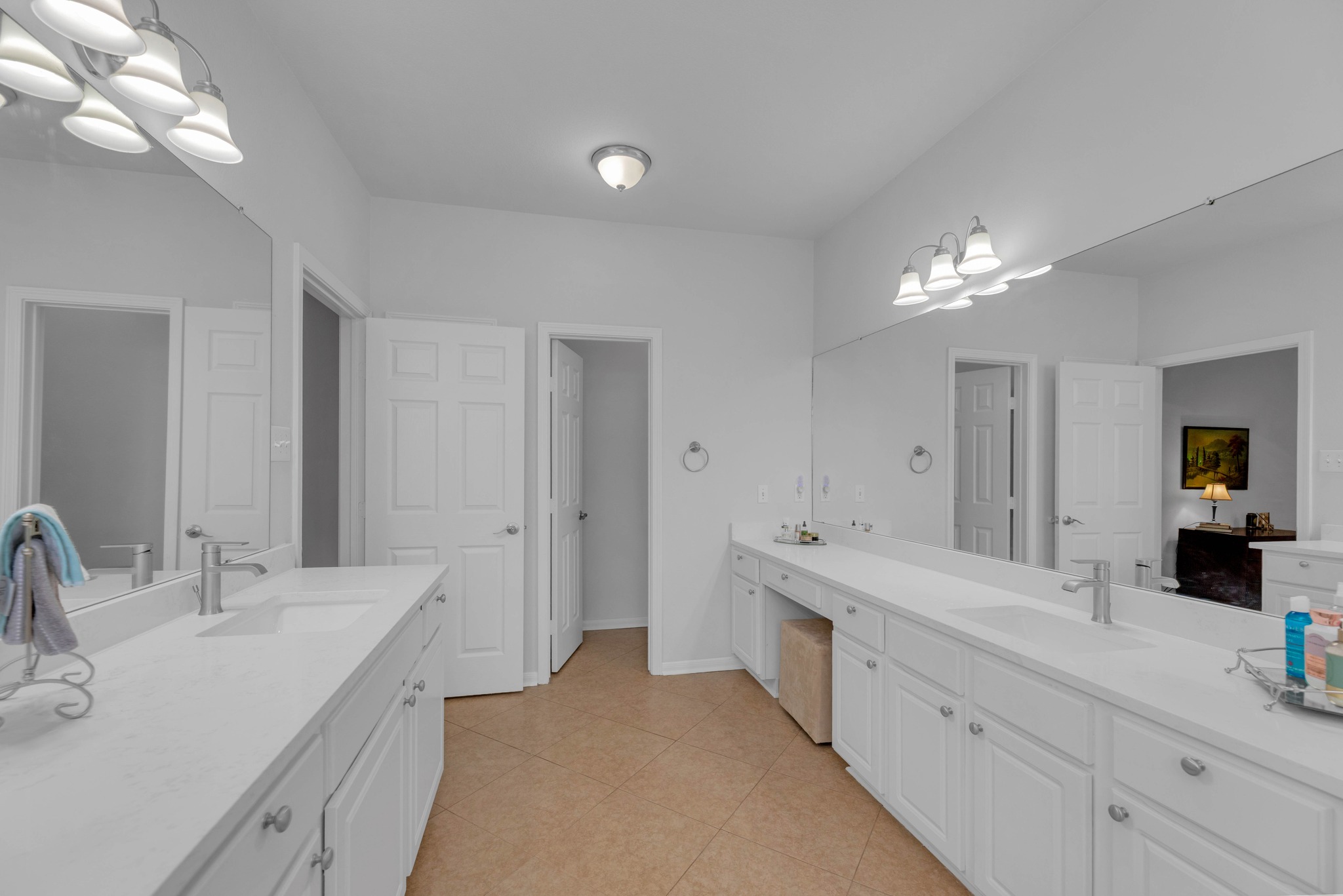 12528 Labrador Cove Austin, TX 78729 - Photo 28 of 40 Primary Bath: Expansive layout with dual vanities, quartz countertops, and ample storage. Bright and functional design with large mirrors and dedicated space for everyday convenience.