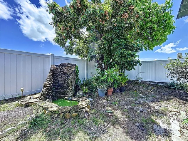 a bedroom with a bed lamp on table and a chandelier