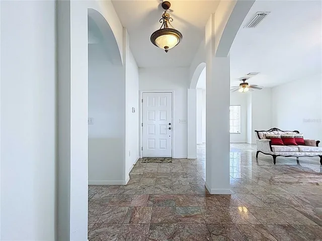 a view of a tennis ground with large trees
