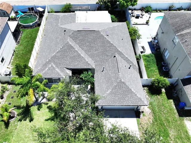 a living room with furniture couches and a dining table with wooden floor