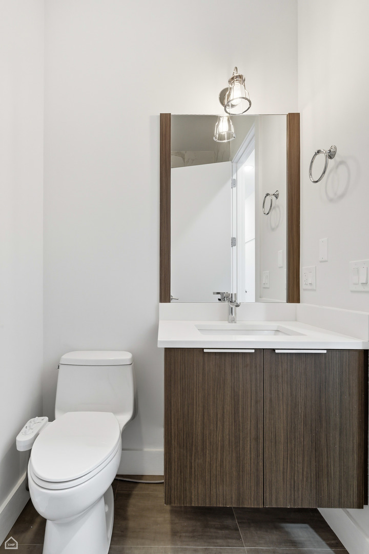 Undisclosed Address Chicago, IL 60622 - Photo 14 of 21 a bathroom with a sink vanity and toilet