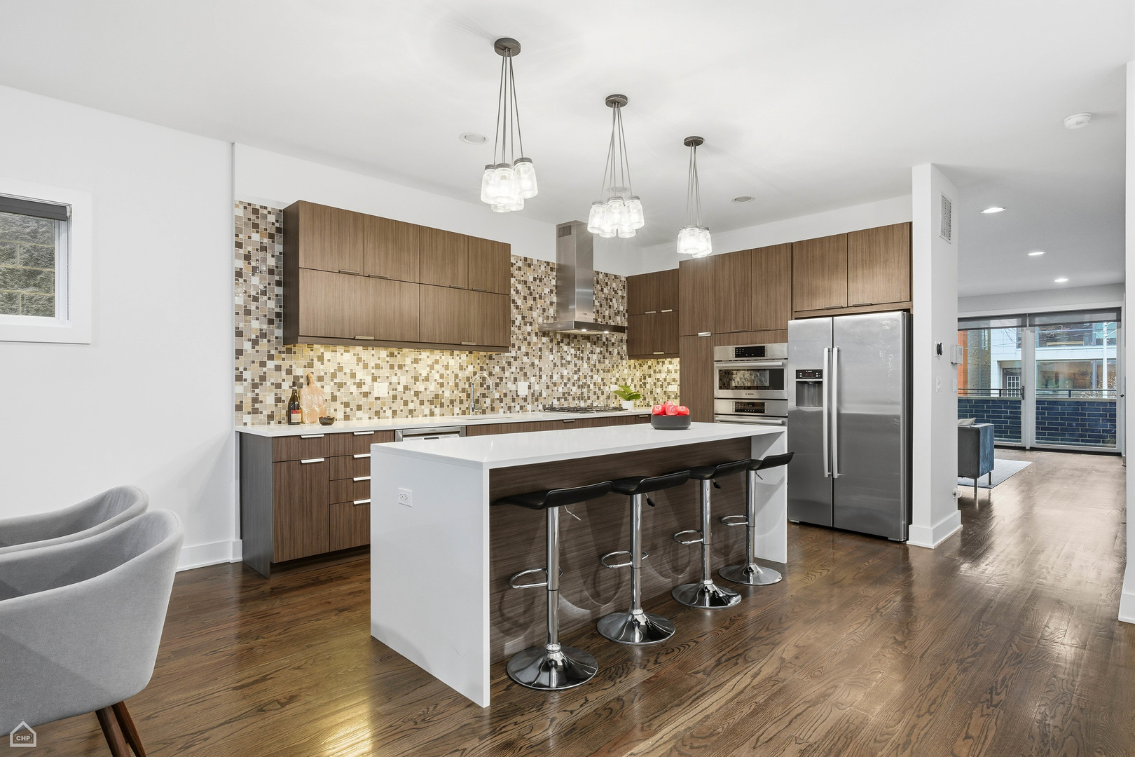Undisclosed Address Chicago, IL 60622 - Photo 3 of 21 a kitchen with stainless steel appliances kitchen island granite countertop a sink a microwave a refrigerator and chairs