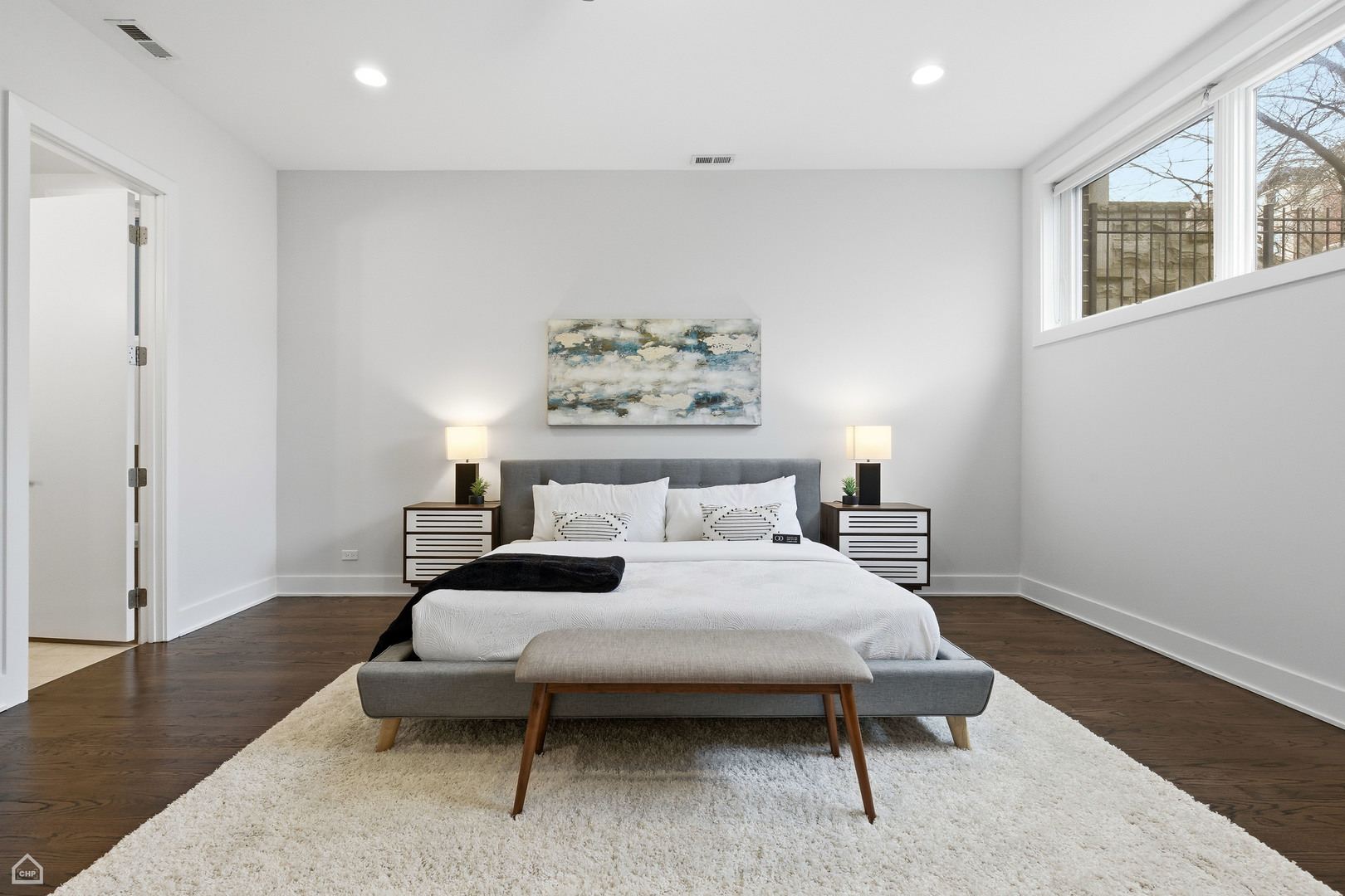 Undisclosed Address Chicago, IL 60622 - Photo 10 of 21 a bedroom with a bed lamp and a window