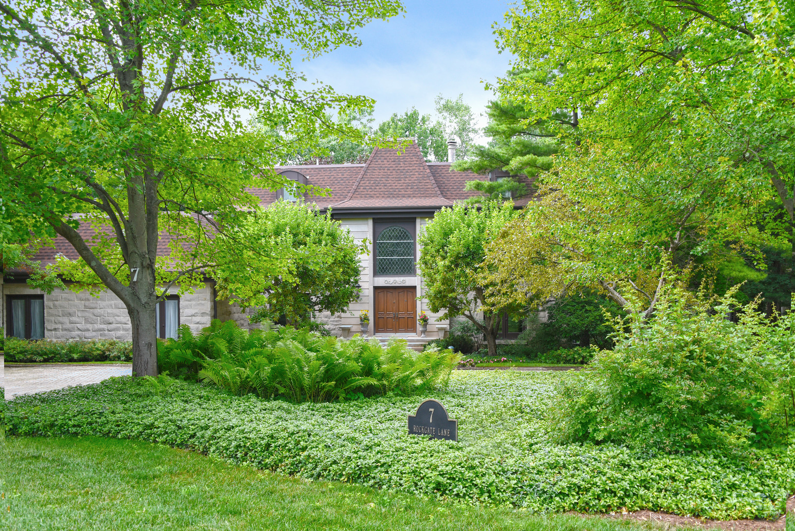 a view of a house with a yard and plants
