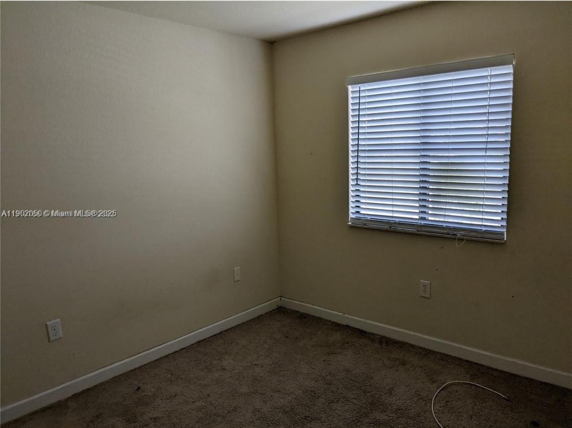 22411 Southwest 88th Place, Unit 926 Cutler Bay, FL 33190 - Photo 13 of 16 an empty room with a window