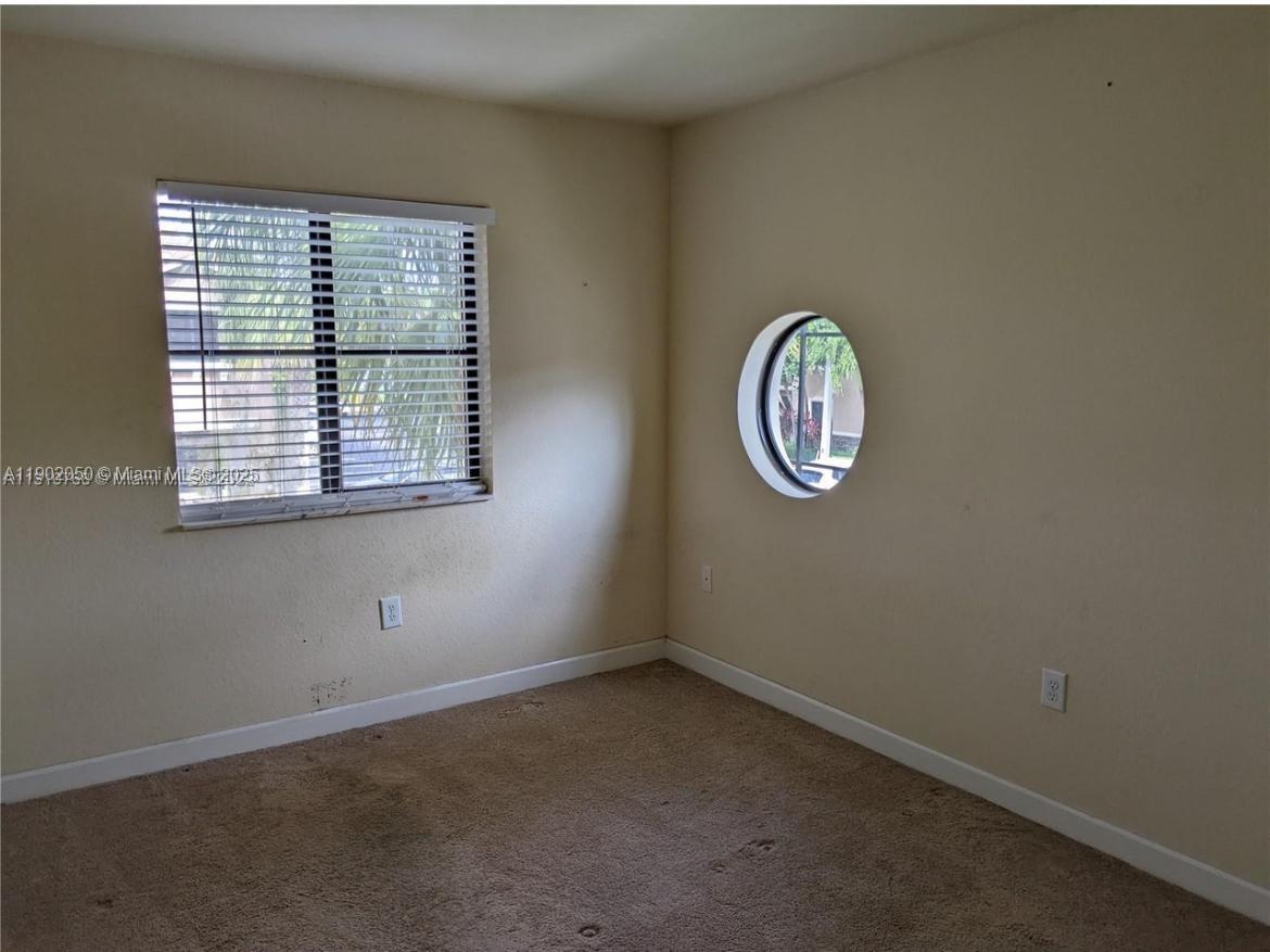22411 Southwest 88th Place, Unit 926 Cutler Bay, FL 33190 - Photo 4 of 16 an empty room with a window