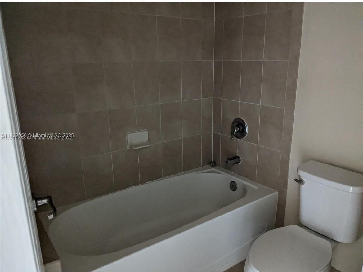 22411 Southwest 88th Place, Unit 926 Cutler Bay, FL 33190 - Photo 6 of 16 a bathroom with a bathtub