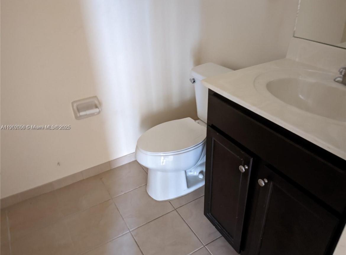 22411 Southwest 88th Place, Unit 926 Cutler Bay, FL 33190 - Photo 10 of 16 a bathroom with a sink and toilet