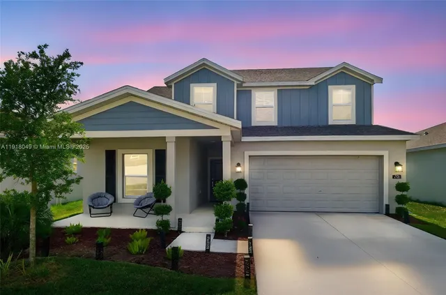 a front view of a house with a yard and garage