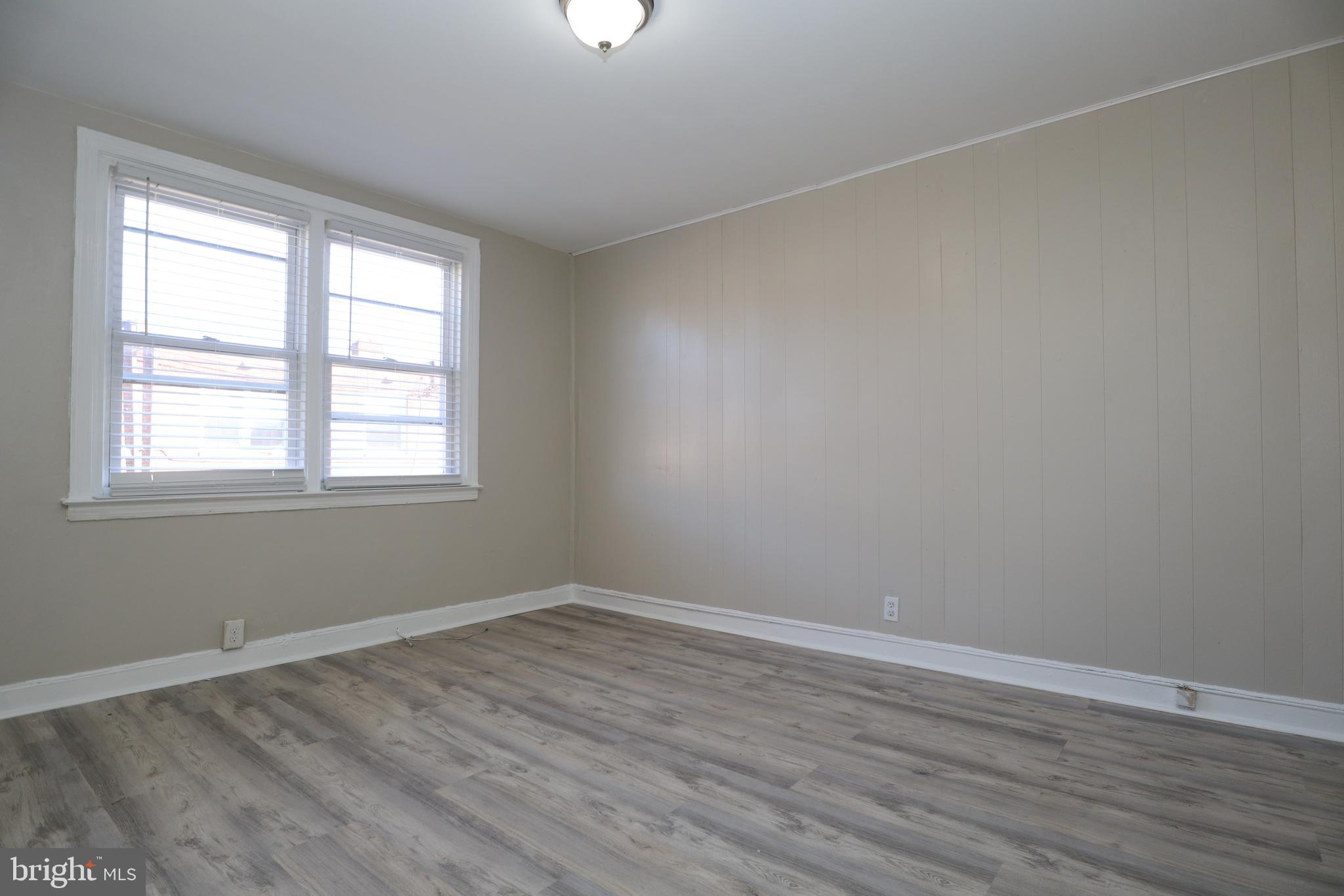 6335 Carnation Street, Unit 2 Philadelphia, PA 19144 - Photo 8 of 35 wooden floor in an empty room with a window