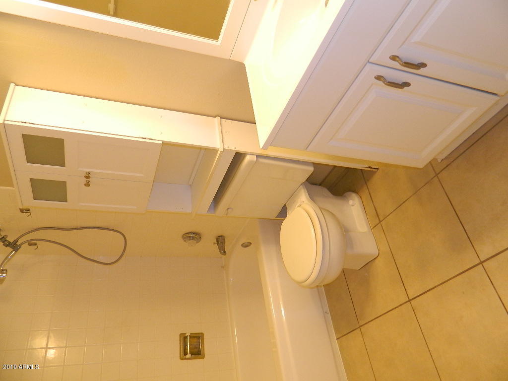 7830 East Camelback Road, Unit 212 Scottsdale, AZ 85251 - Photo 15 of 45 a bathroom with a sink and mirror