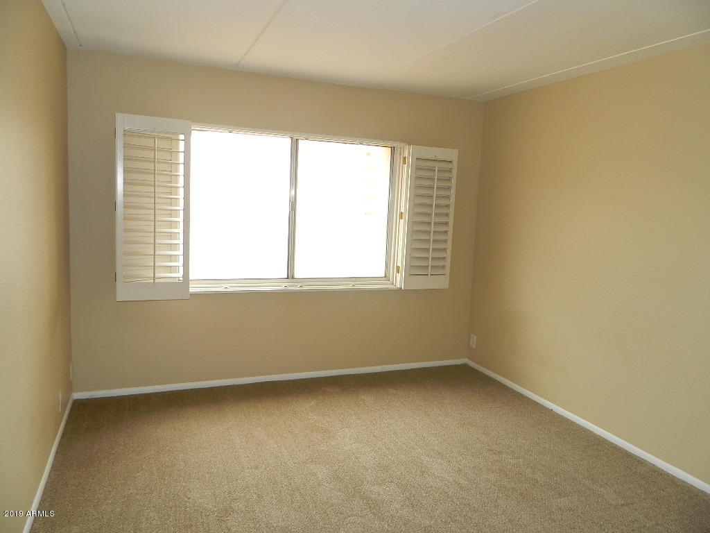 7830 East Camelback Road, Unit 212 Scottsdale, AZ 85251 - Photo 17 of 45 an empty room with a window