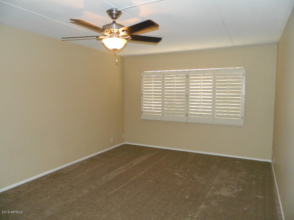 7830 East Camelback Road, Unit 212 Scottsdale, AZ 85251 - Photo 20 of 45 an empty room with windows and fan