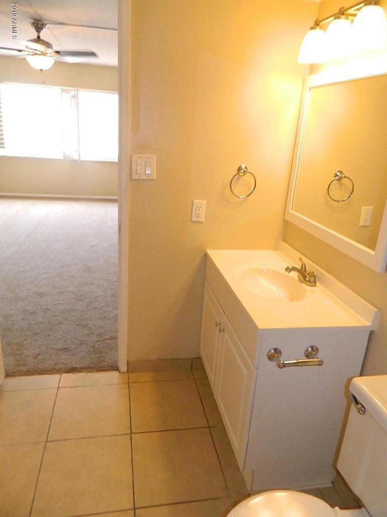 7830 East Camelback Road, Unit 212 Scottsdale, AZ 85251 - Photo 23 of 45 a bathroom with a sink a toilet and shower