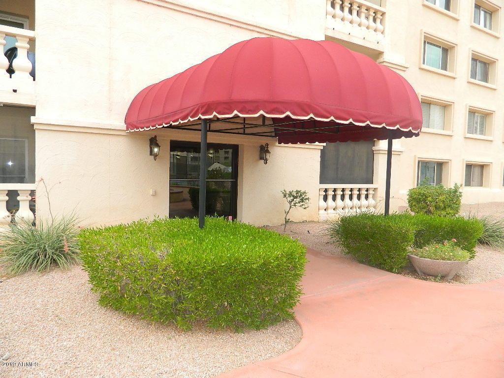 7830 East Camelback Road, Unit 212 Scottsdale, AZ 85251 - Photo 28 of 45 a front view of a house with a yard