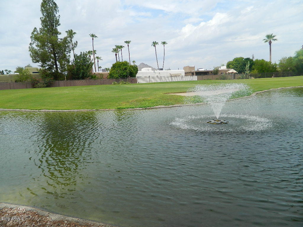 7830 East Camelback Road, Unit 212 Scottsdale, AZ 85251 - Photo 36 of 45 a view of a golf course with a lake
