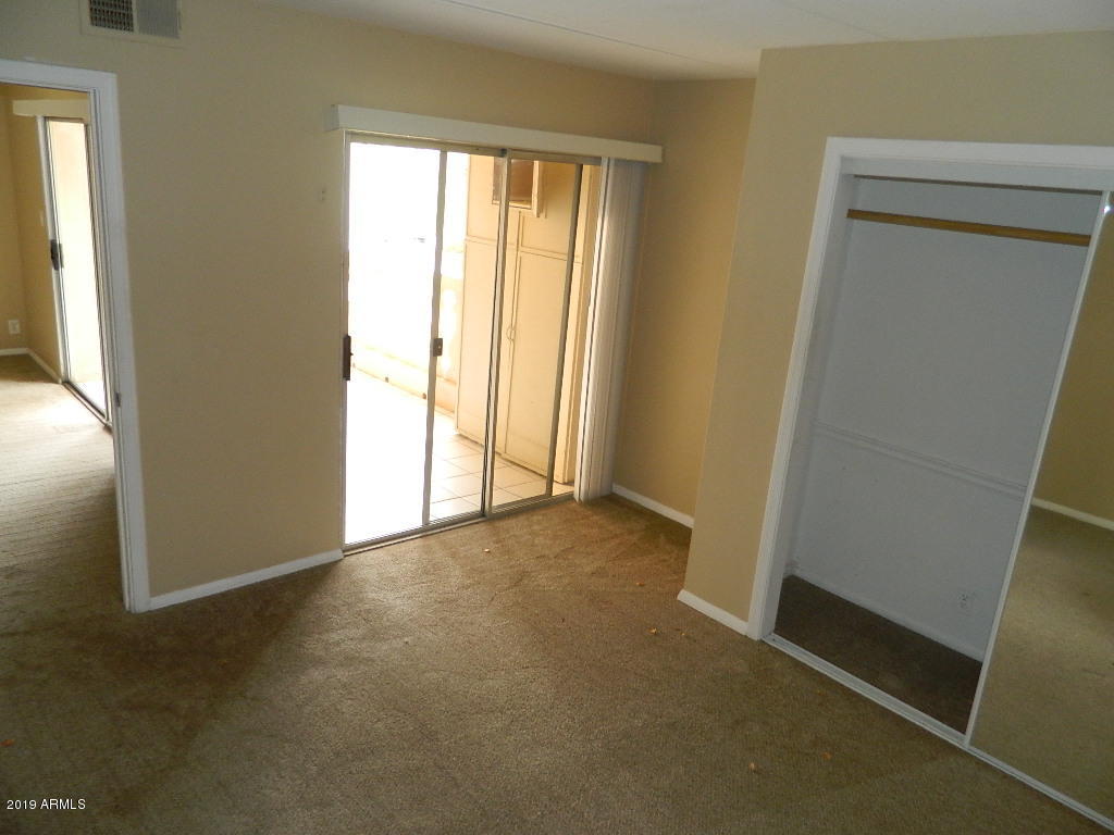 7830 East Camelback Road, Unit 212 Scottsdale, AZ 85251 - Photo 8 of 45 an empty room with windows