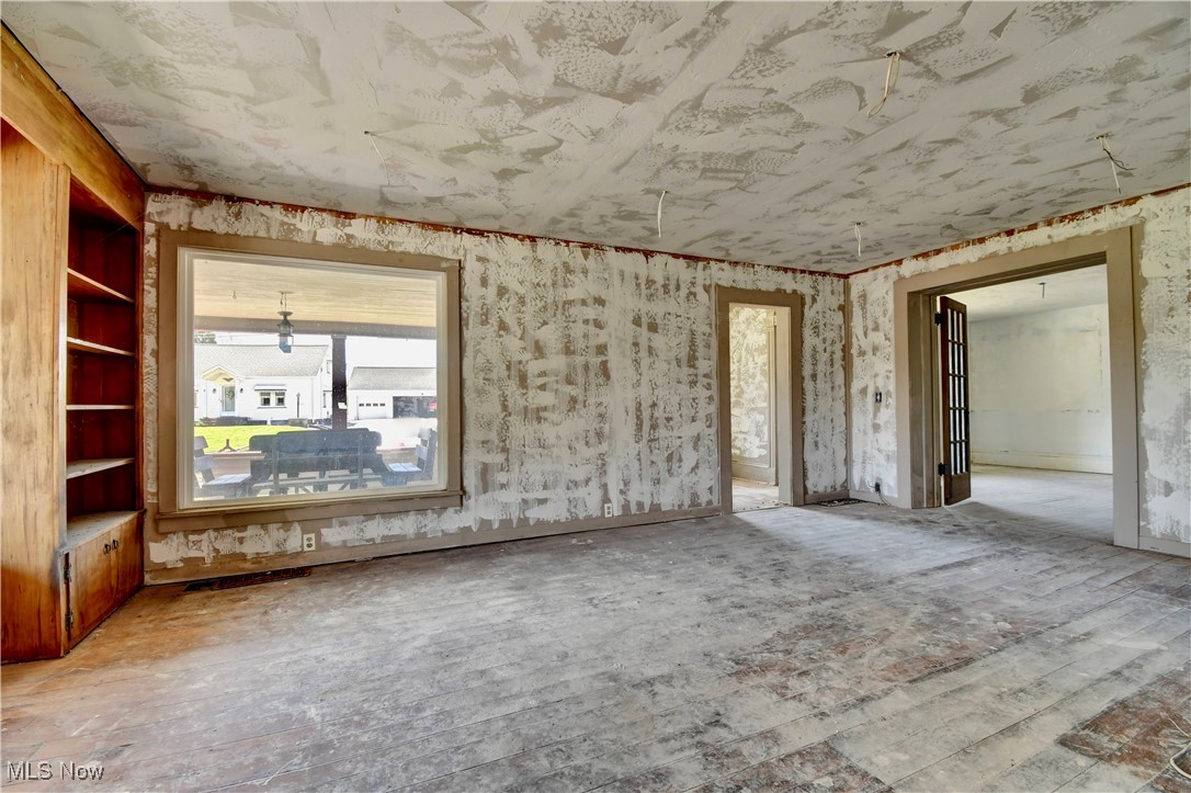 14875 Navarre Road Southwest Wilmot, OH 44689 - Photo 16 of 40 Empty room with wood-type flooring