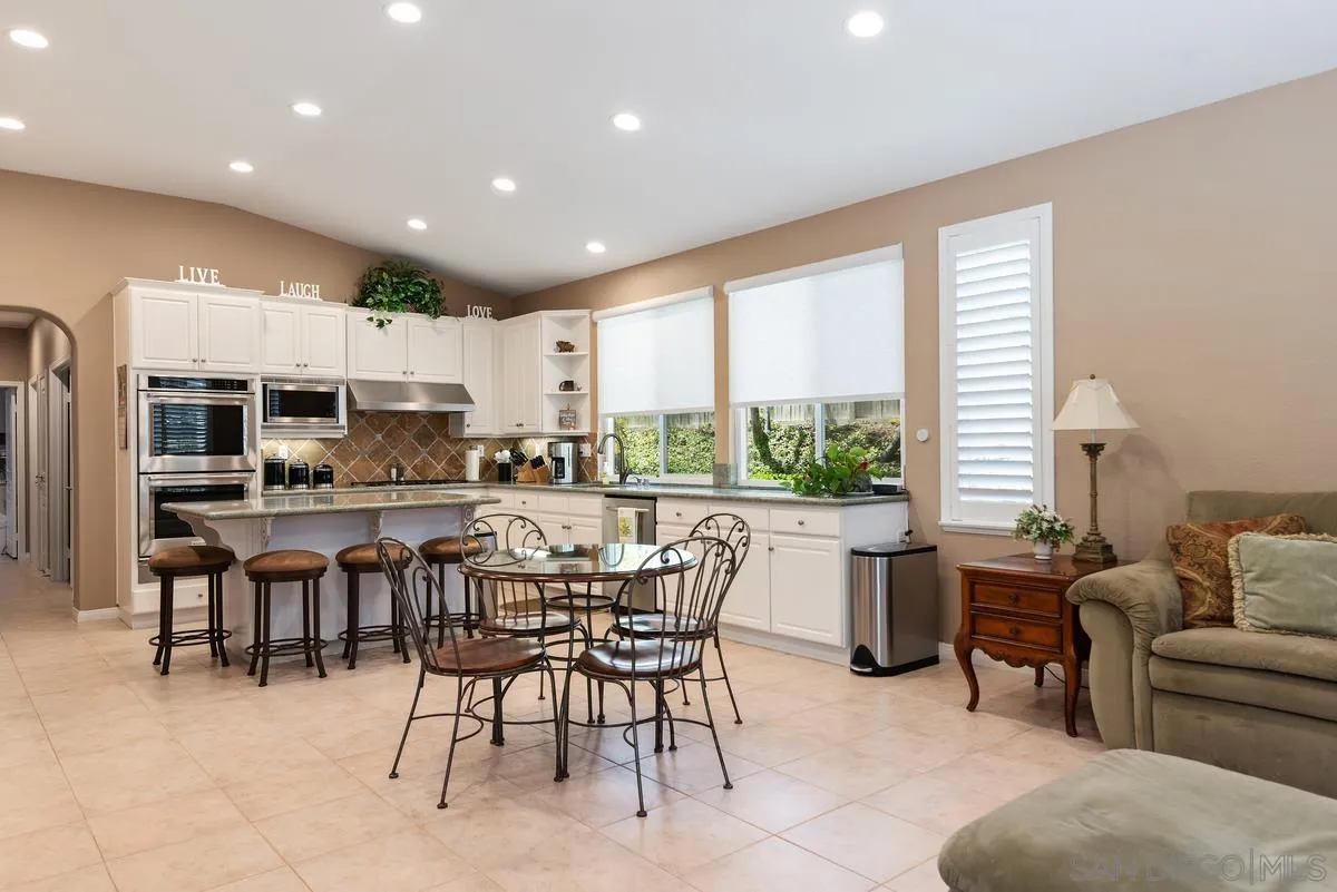 1374 Sparrow Road Carlsbad, CA 92011 - Photo 17 of 33 a large kitchen with a table and chairs