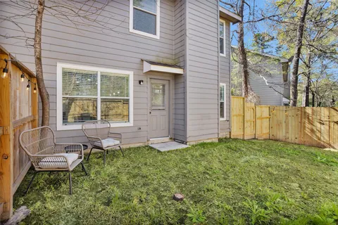 a view of a house with backyard and sitting area