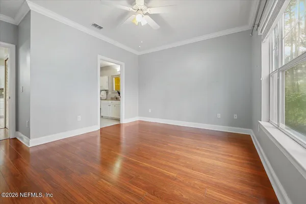 a bedroom with a large bed and a window