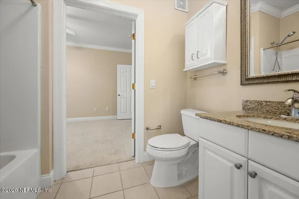 a view of a kitchen with white cabinets