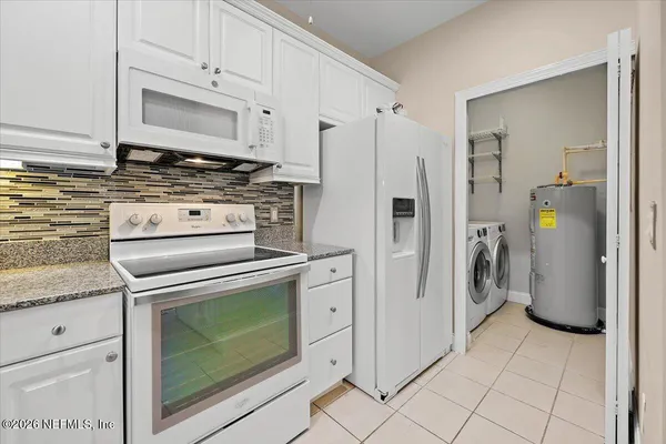 a bathroom with a granite countertop sink a toilet and a large mirror