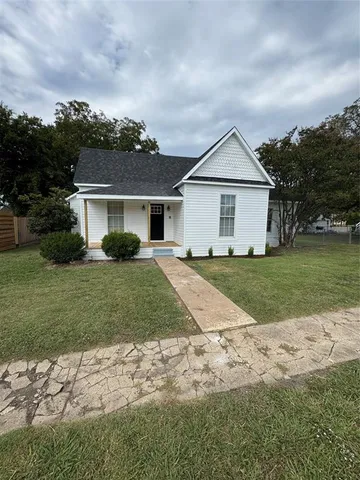 a front view of house with yard and green space