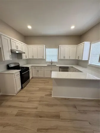 a view of kitchen with wooden floor