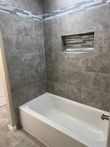 a bathroom with a shower and a bath tub