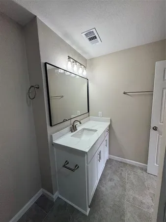 a bathroom with a sink toilet and mirror