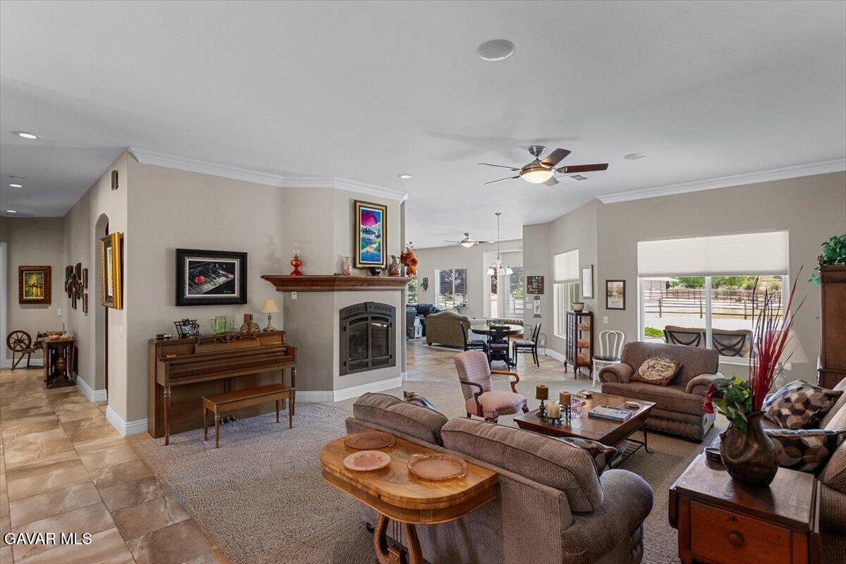 23840 Martingale Way Tehachapi, CA 93561 - Photo 11 of 63 a living room with furniture a fireplace and a flat screen tv