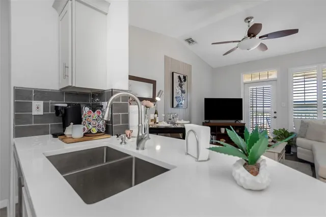 a spacious bedroom with a bed and a chandelier