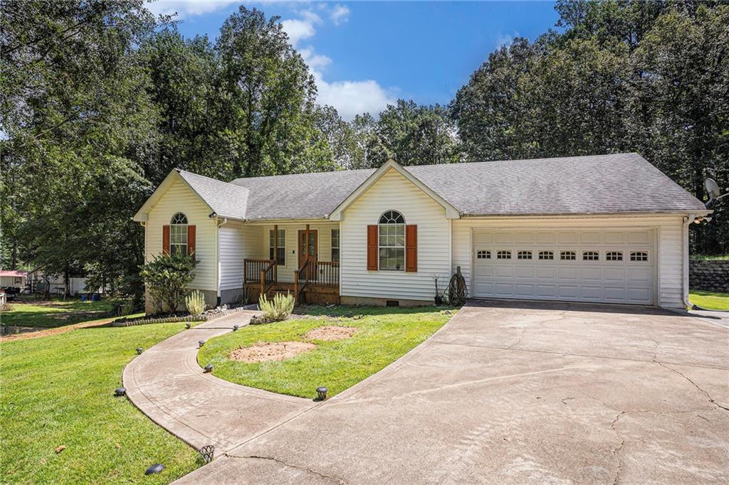 165 Springvalley Way Stockbridge, GA 30281 - Photo 1 of 1 a front view of a house with a yard and garage