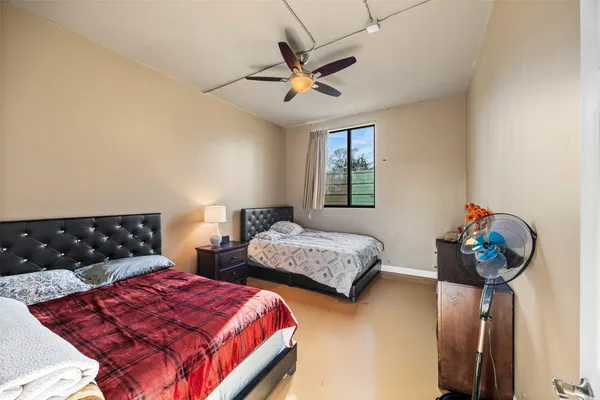 a bedroom with bed and window