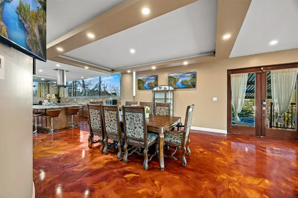 a living room with furniture a fireplace and a floor to ceiling window