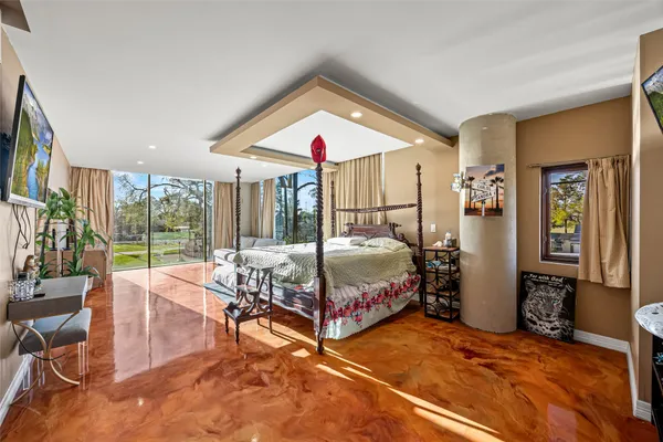 a room with pool table and potted plants