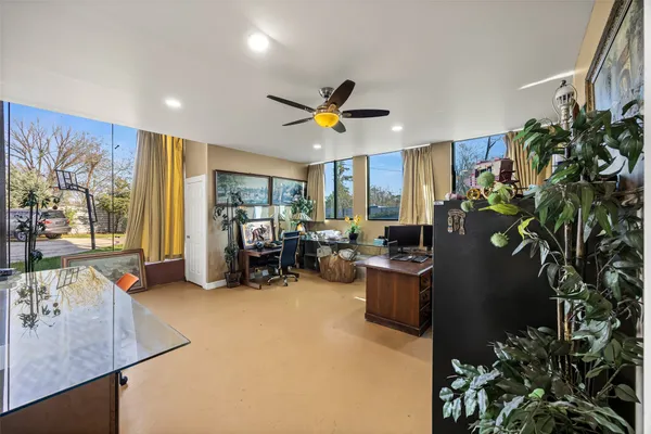 a view of a livingroom with workspace and a window