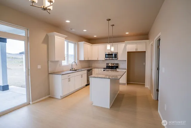 a kitchen with a refrigerator a sink and cabinets
