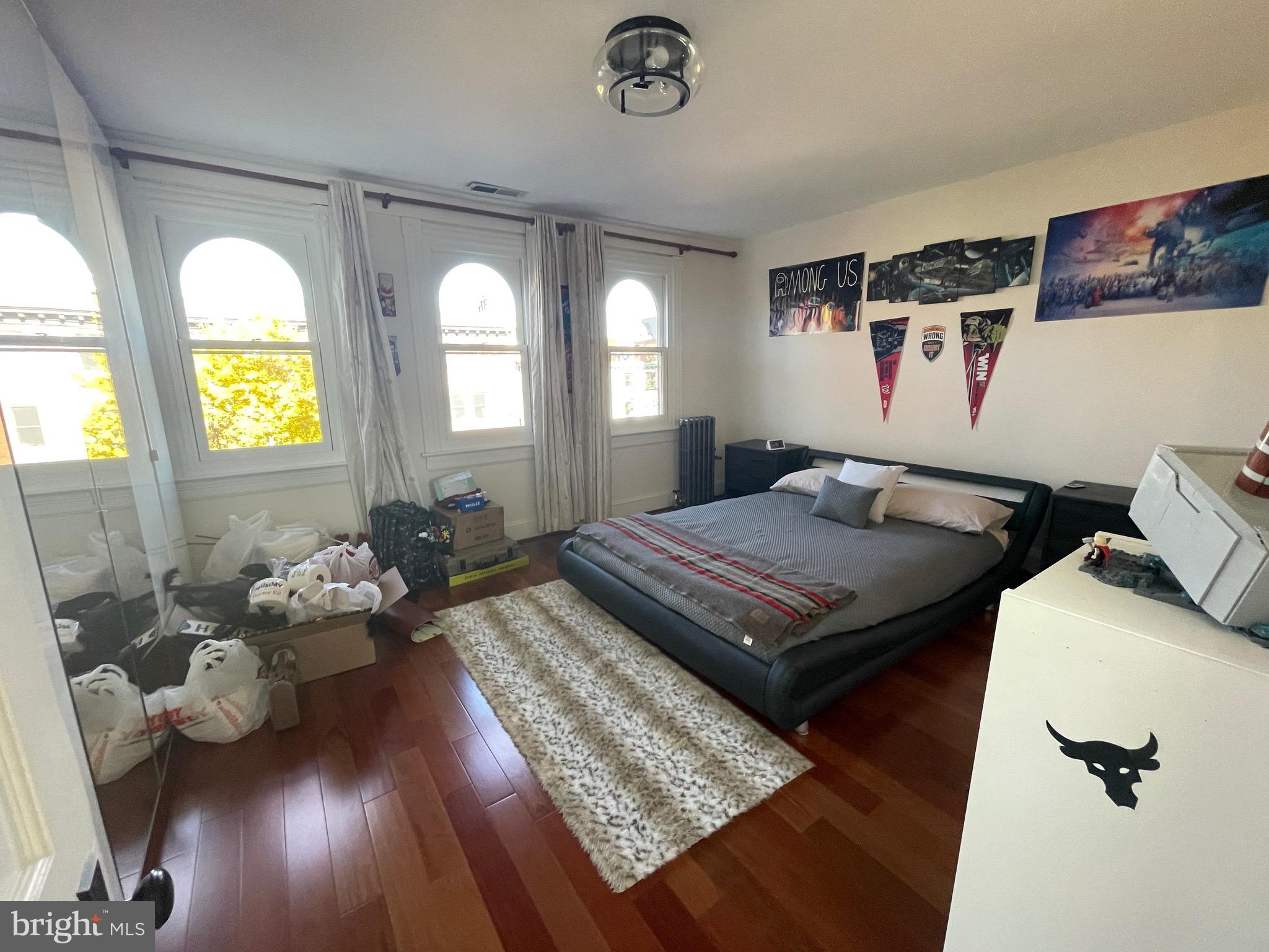 1750 T Street Northwest, Unit B Washington, DC 20009 - Photo 13 of 14 a living room with a couch and a chandelier