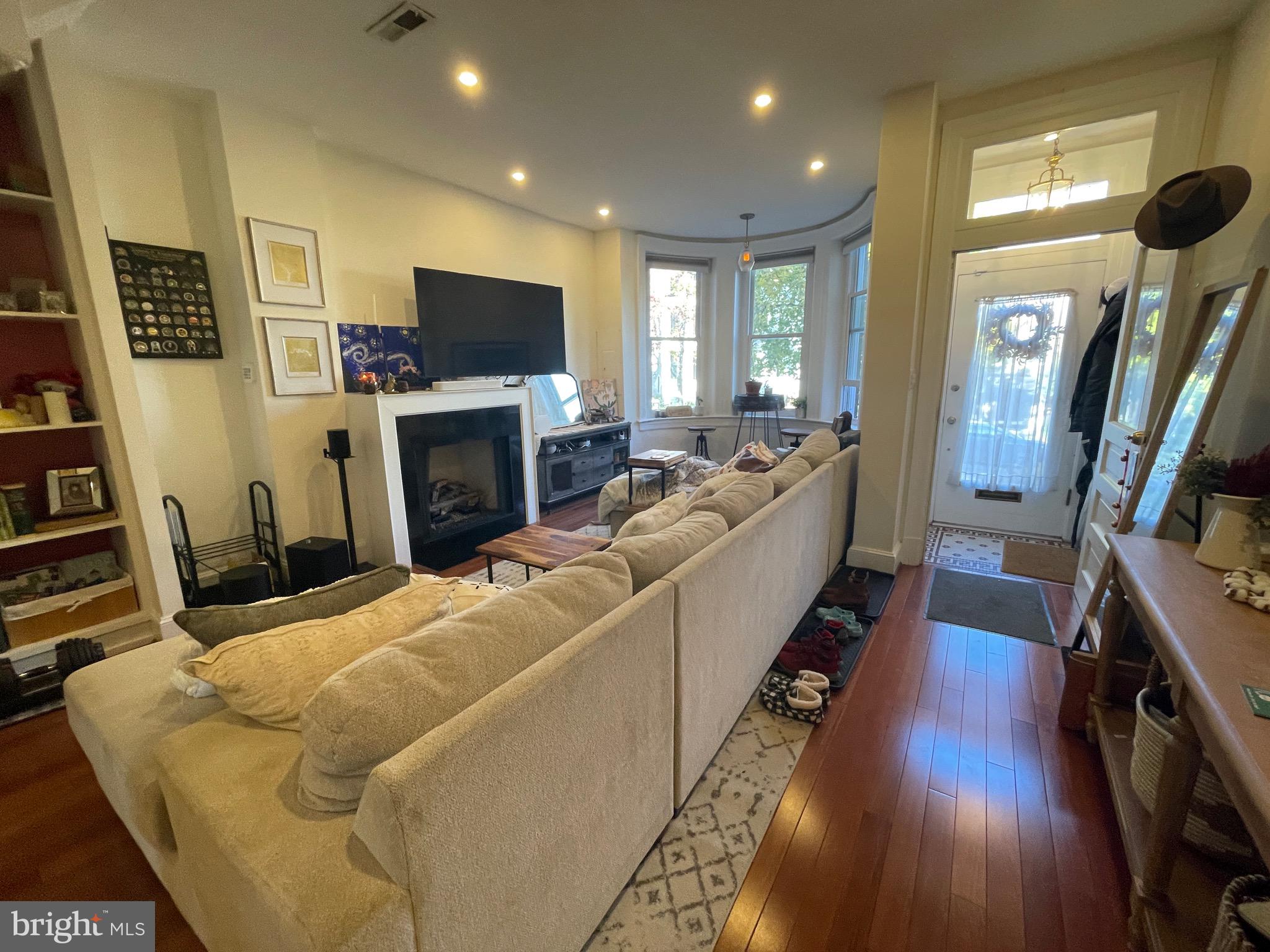 1750 T Street Northwest, Unit B Washington, DC 20009 - Photo 2 of 14 a living room with furniture a flat screen tv and a fireplace